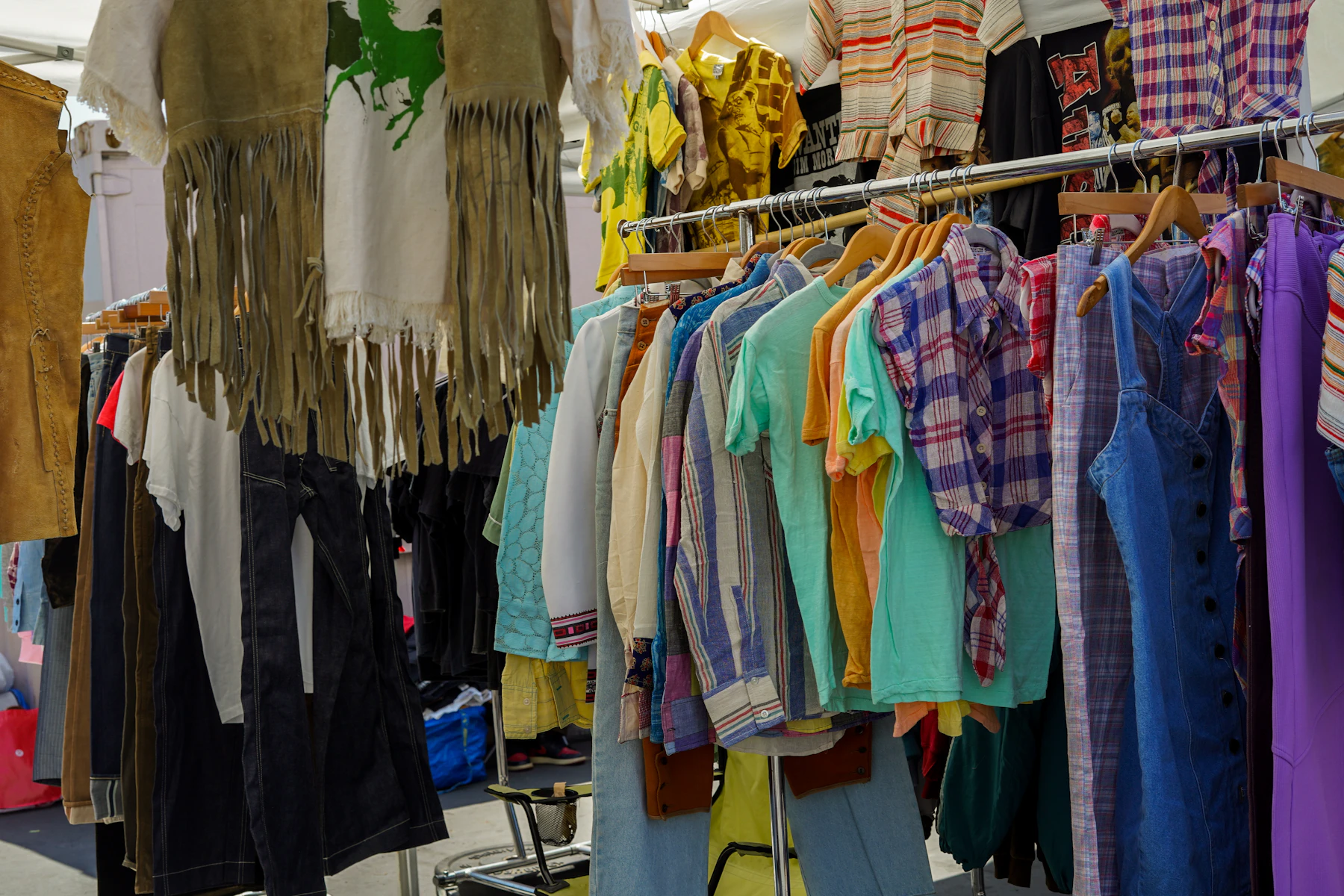 a rack of shirts and pants hanging on a clothes rack