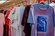 a bunch of shirts hanging on a rack