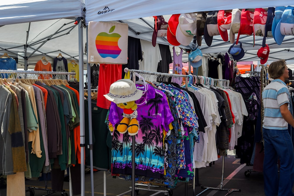 a woman standing in front of a display of clothing