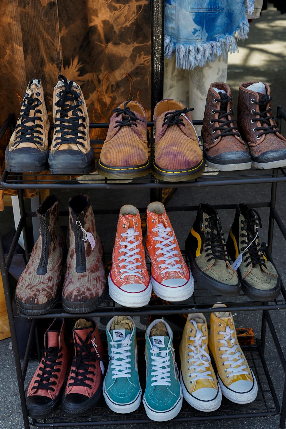 several pairs of shoes are on a rack