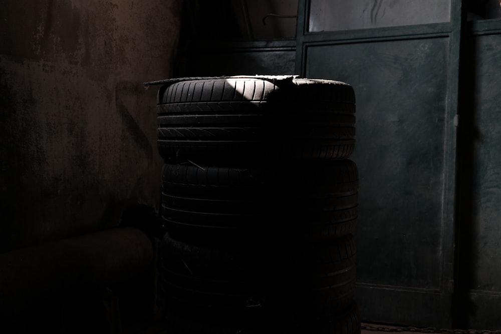 a stack of tires sitting in a dark room
