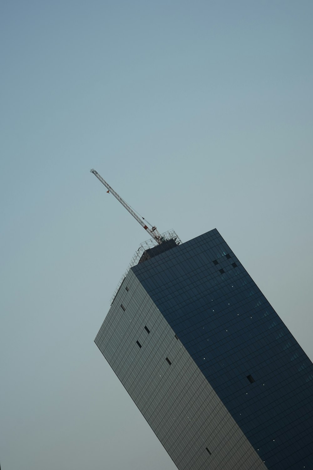 a tall building with a crane on top of it