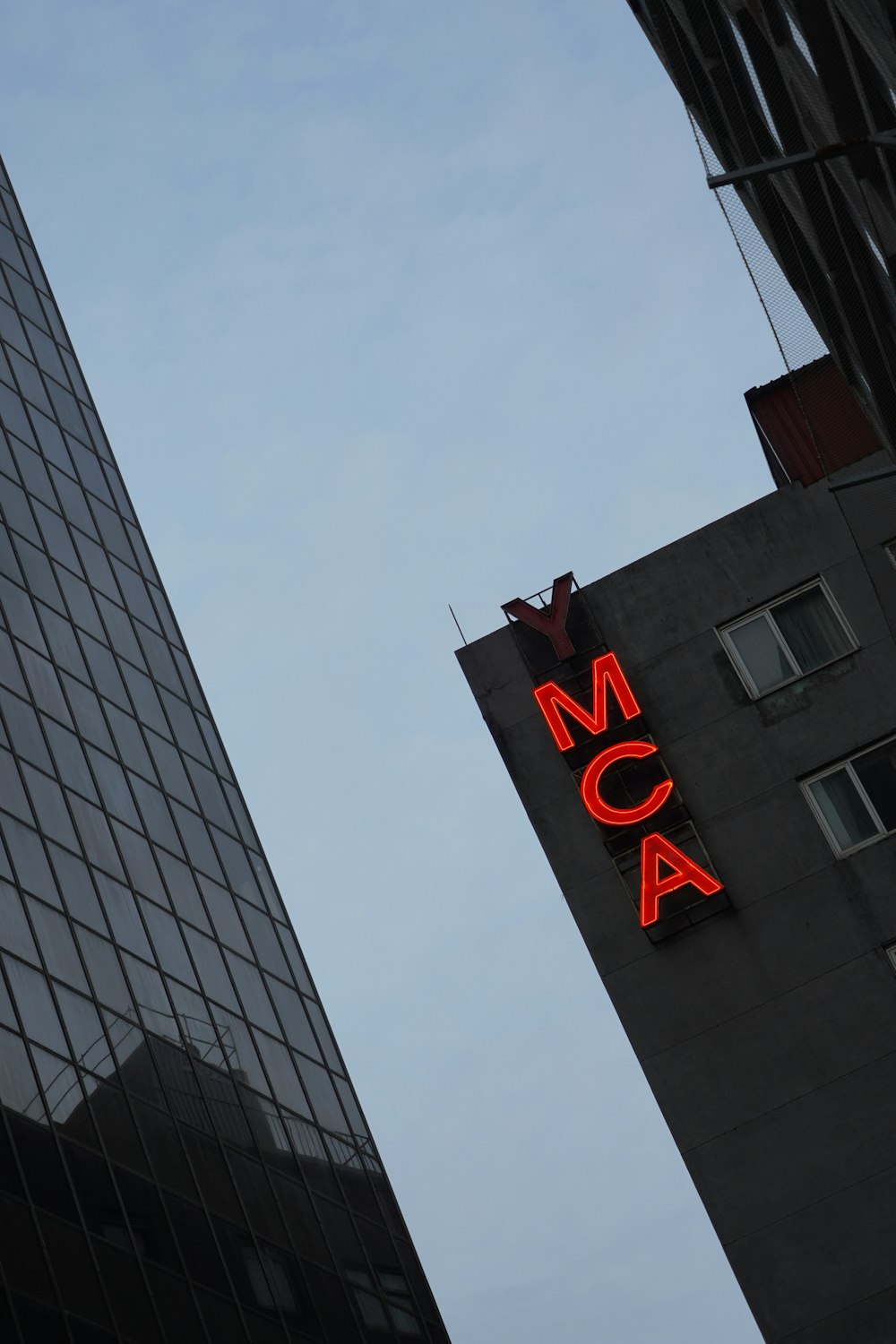 a tall building with a neon sign on the side of it