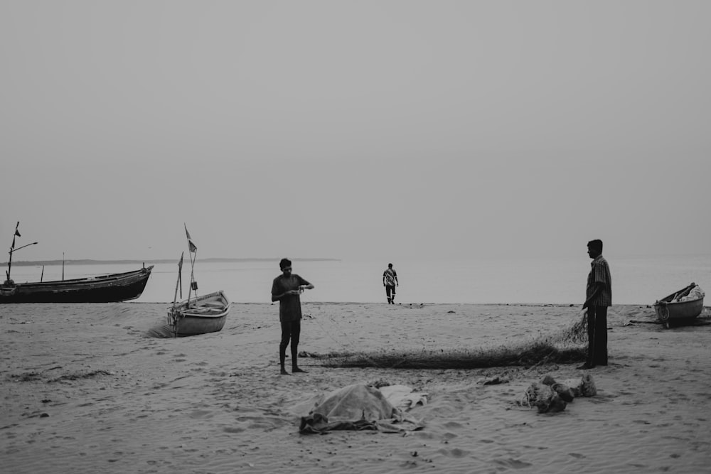 a group of people standing on top of a sandy beach