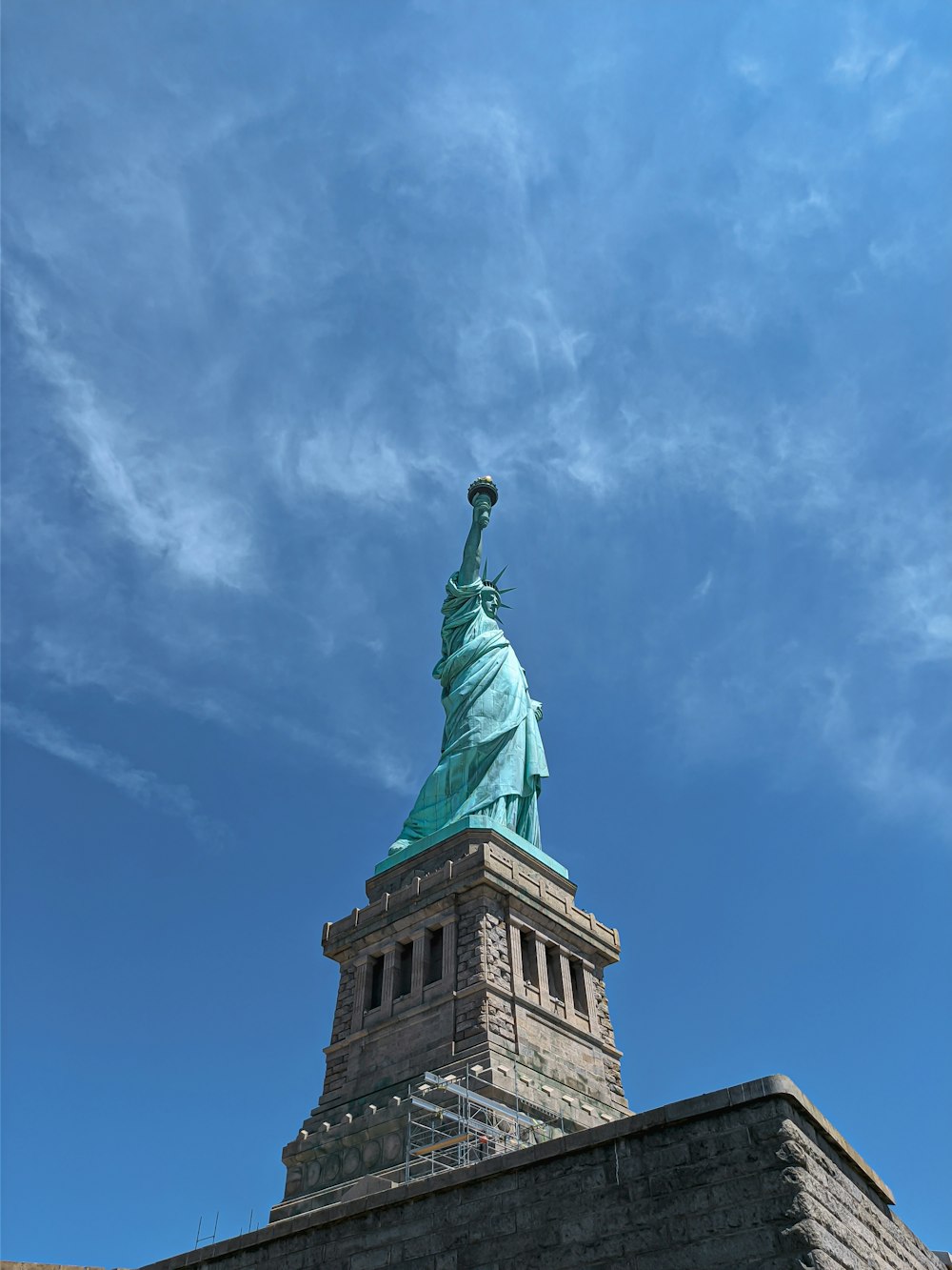 a view of the statue of liberty from the top of a building