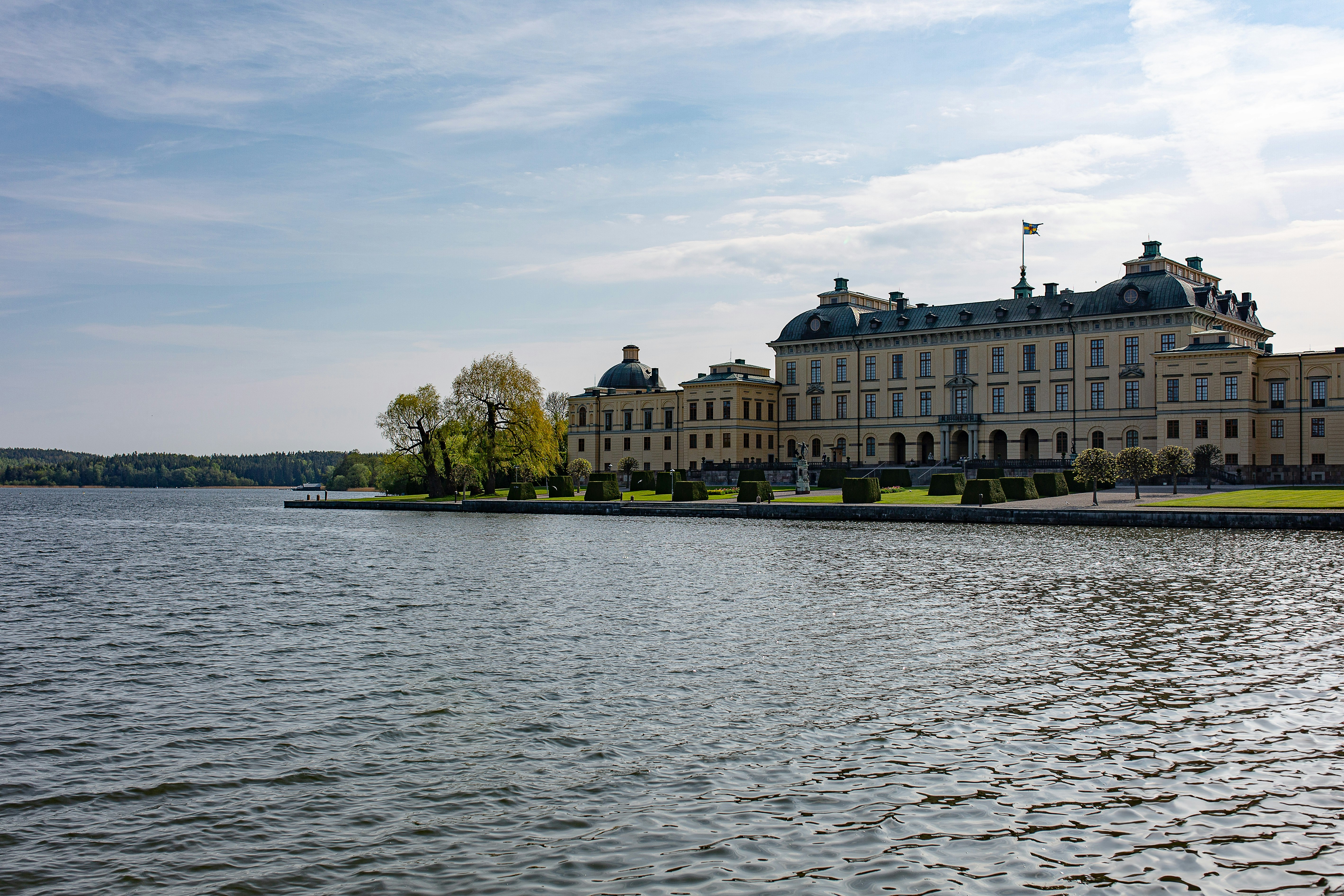 a large building sitting on the side of a lake