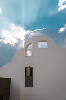 A serene, minimalist facade of a premium Georgetown property bathed in soft, canvas-white light.