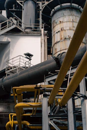 a large metal pipe sitting next to a building