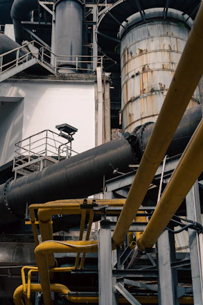 a large metal pipe sitting next to a building