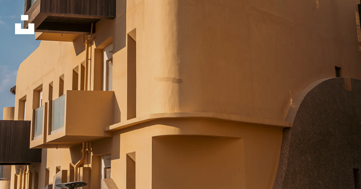 Tan Building A tan building with a balcony and balconies photo – Free City Image on ...