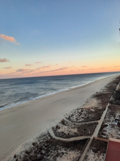 Evening beach scene with gentle waves and a pastel sunset sky near Vilano Breeze