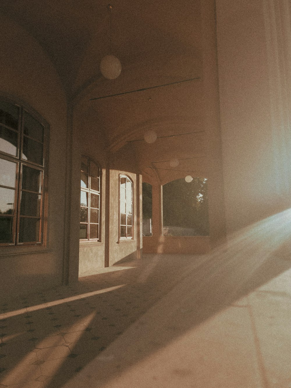 the sun is shining through the windows of a building