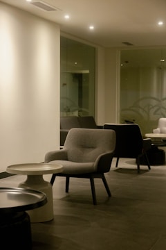 Minimalist event lounge area with sleek furniture and subtle gray accents.