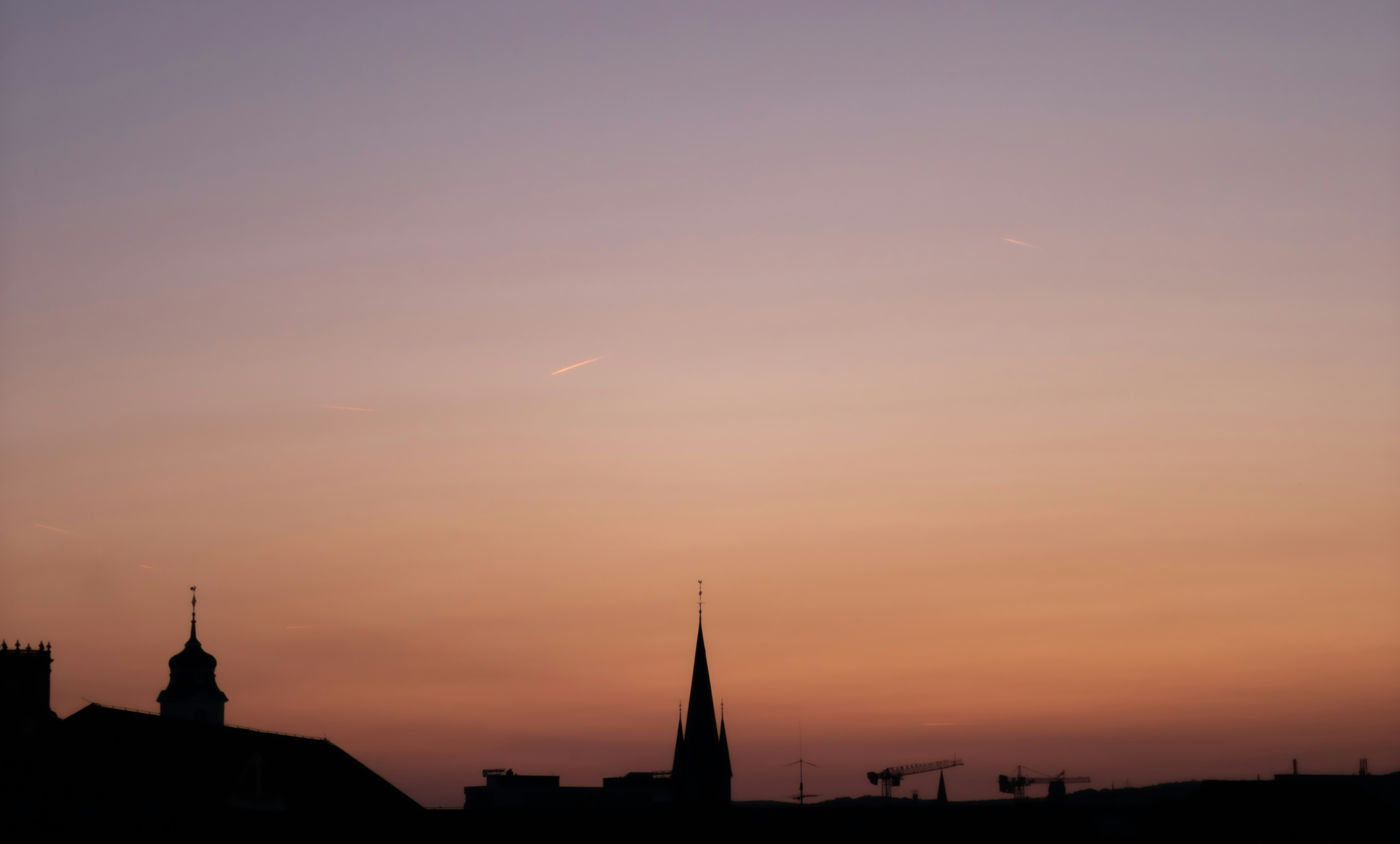 A sunset view of a church steeple with a plane in the sky photo – Free ...