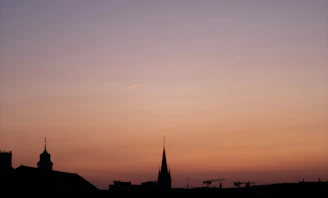 A sleek architectural blueprint overlaying a city skyline at dusk, highlighting structural details.