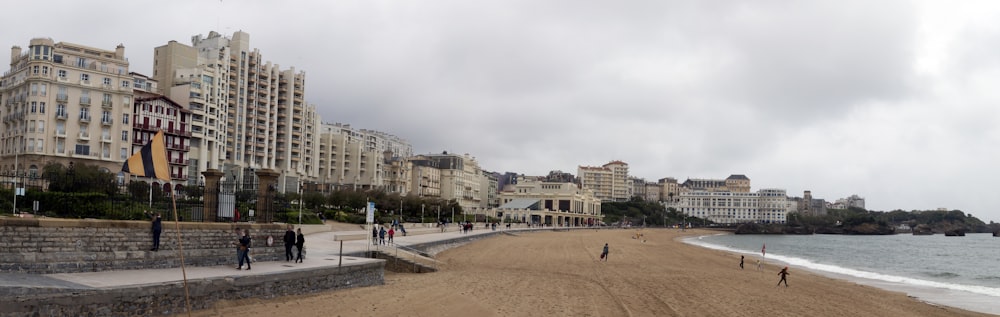 a sandy beach with people walking on it