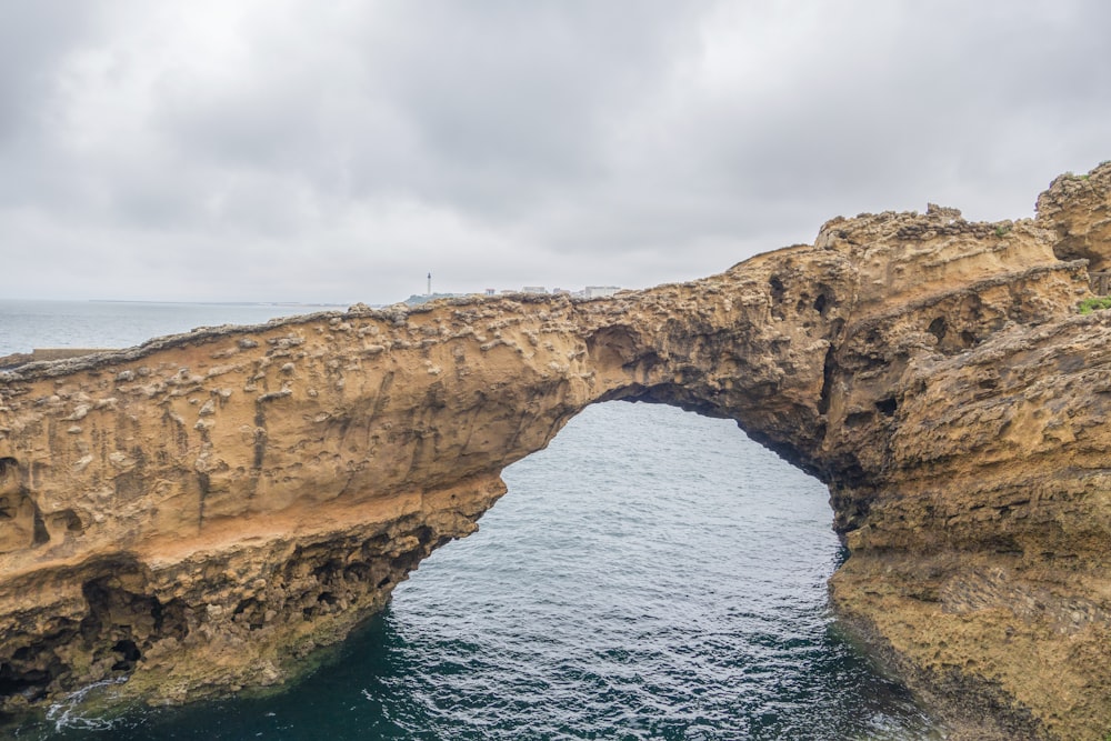 a large rock bridge over a body of water