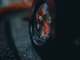 Shiny black tires with a glossy tire shine reflecting soft ambient light on a dark background.