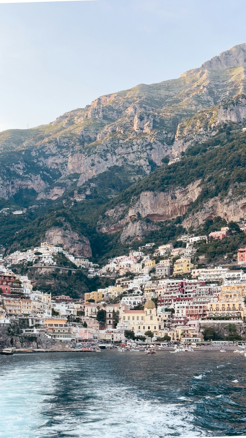 a view of a town on the shore of a body of water