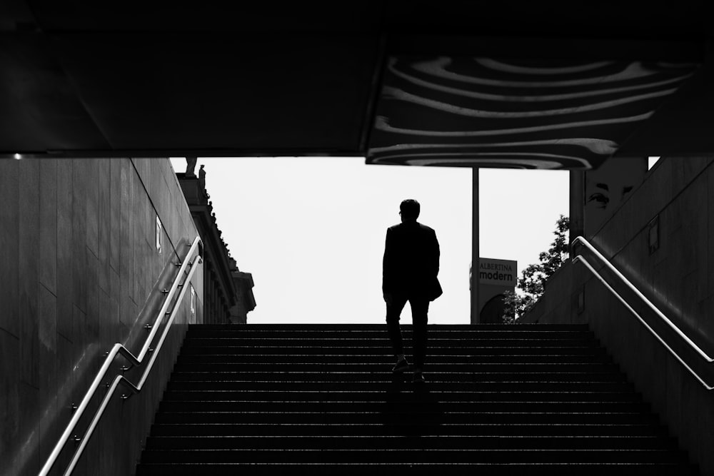 a man is standing on a set of stairs