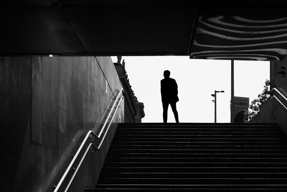 a man standing on top of a set of stairs