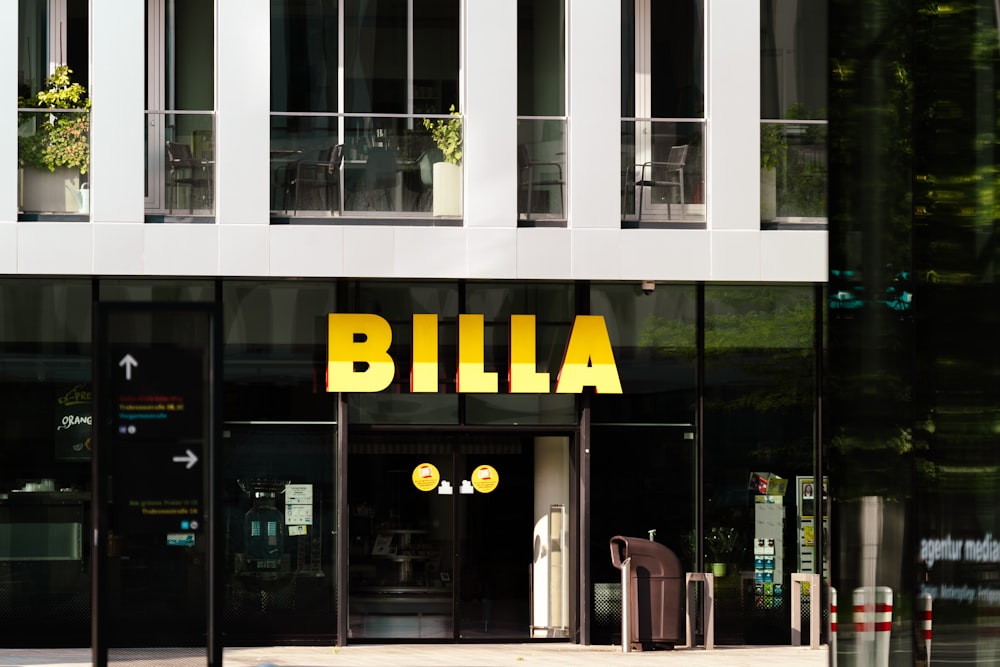 a tall building with a yellow sign that says billa