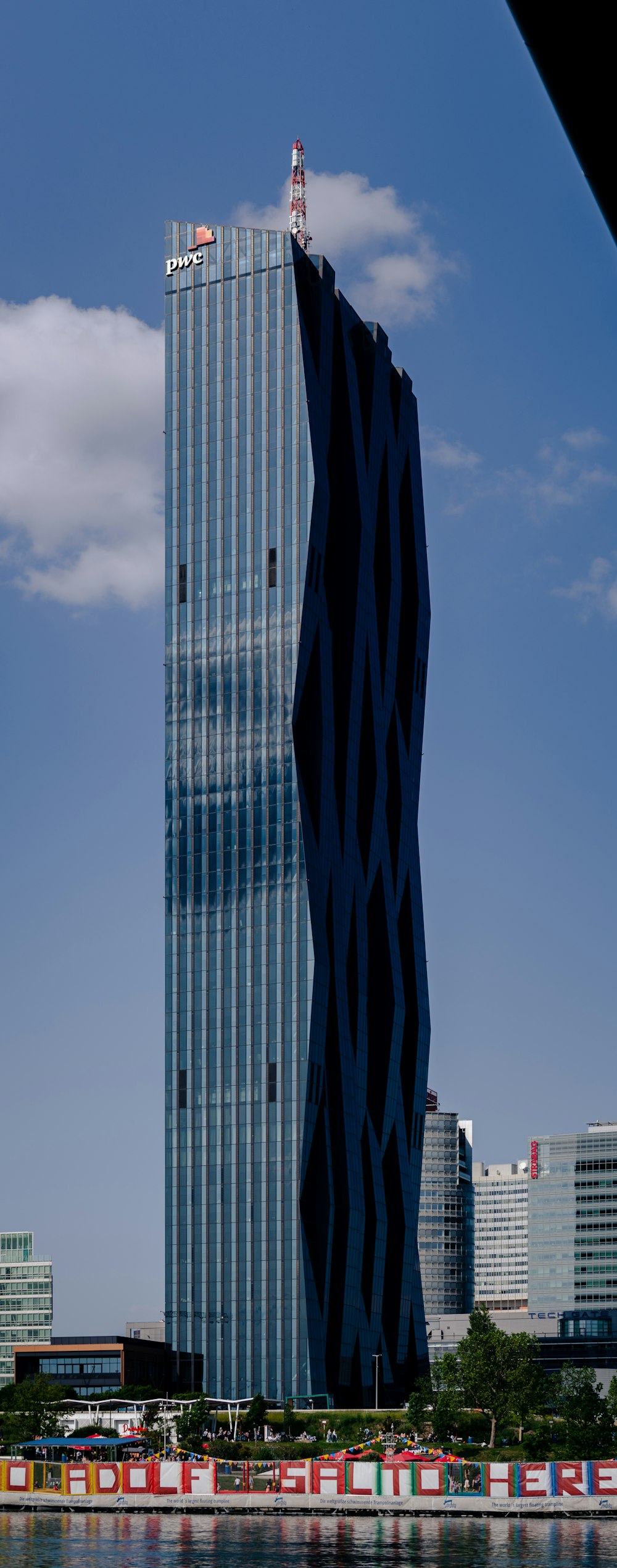 a tall building sitting next to a body of water
