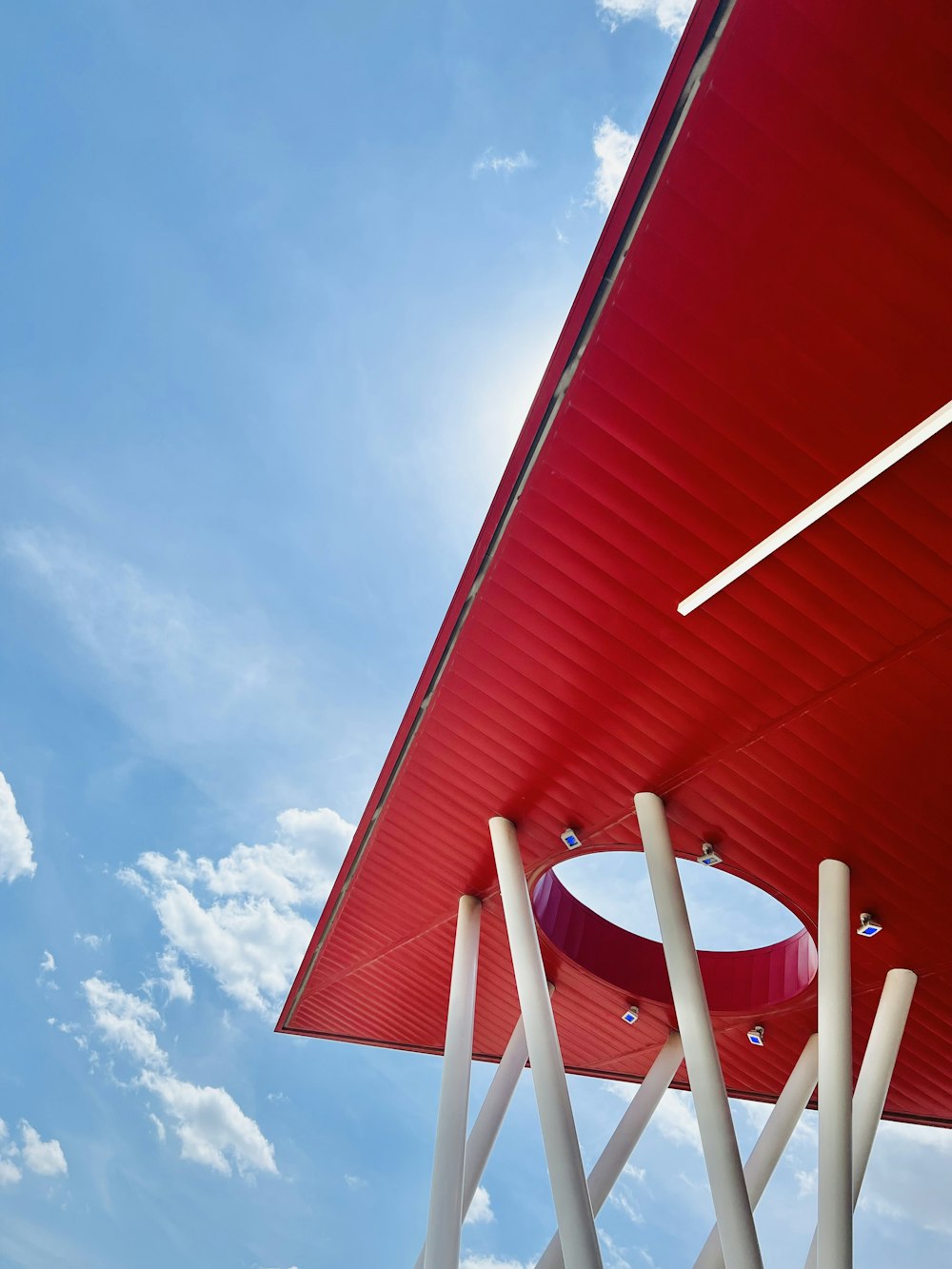 a large red structure with a sky in the background
