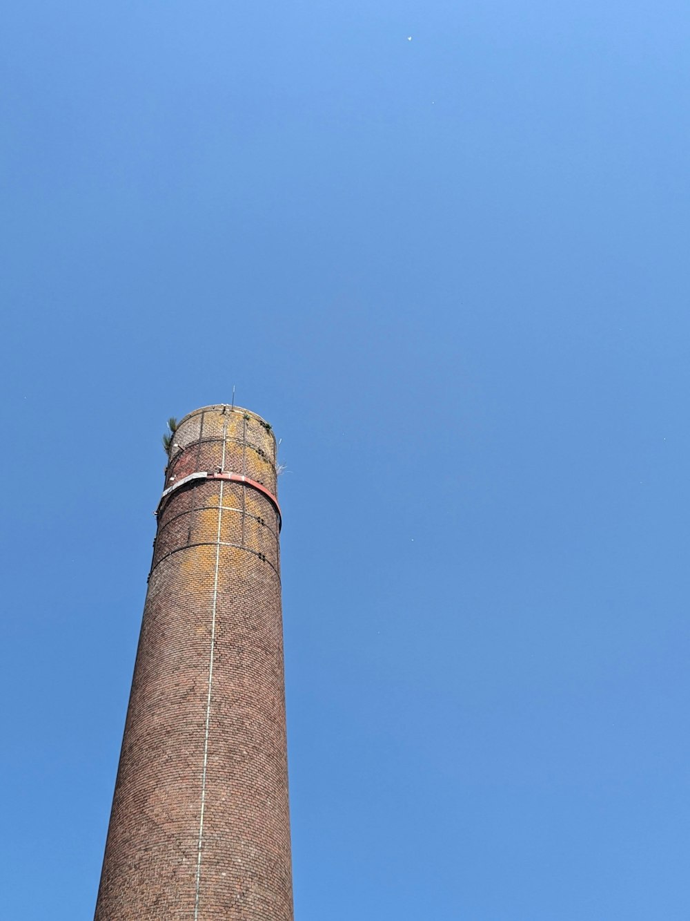 a tall brick tower with a blue sky in the background