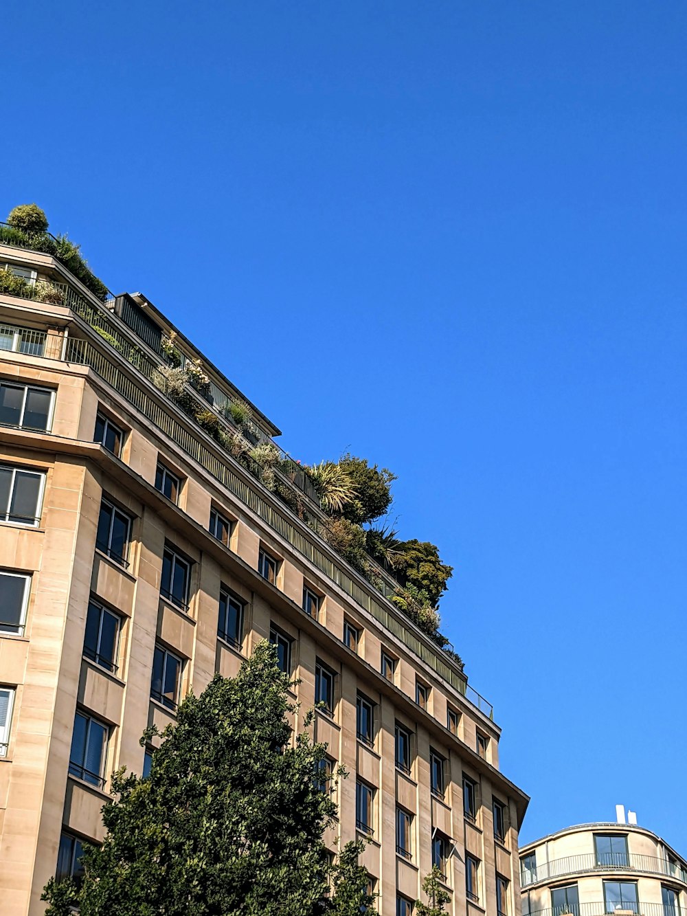 a very tall building with a green roof