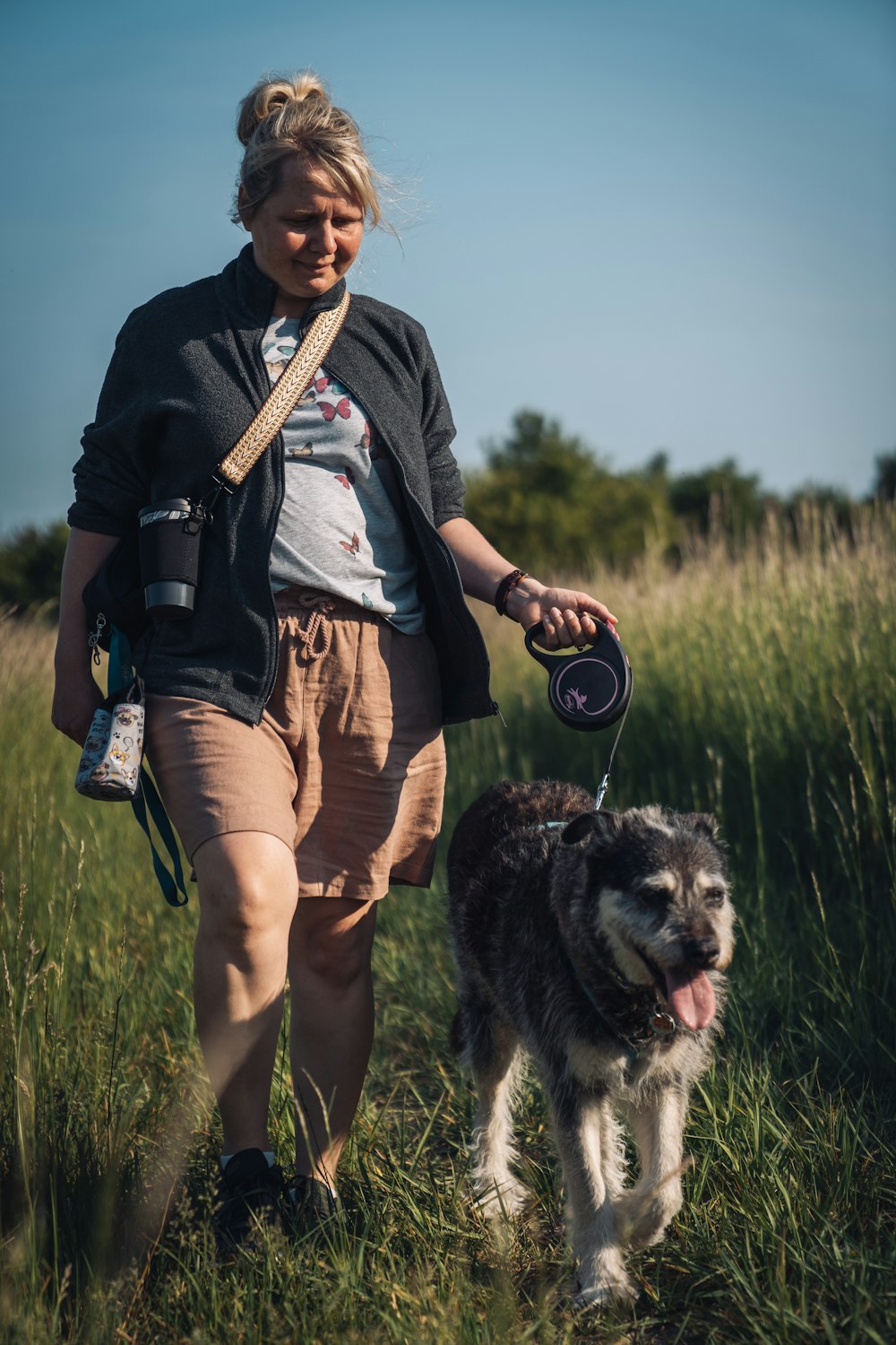 a woman walking a dog on a leash