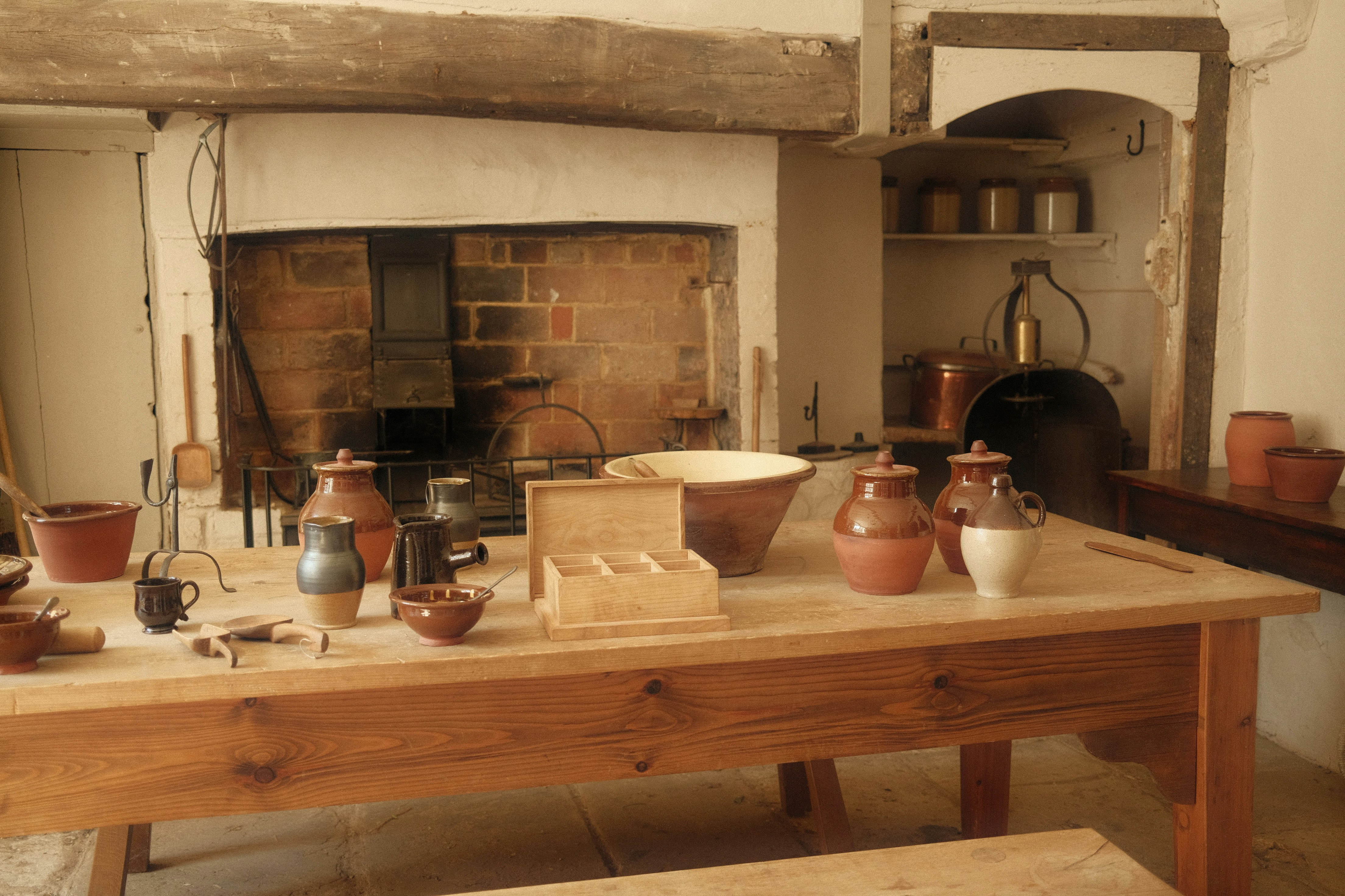 a wooden table topped with lots of pots and pans