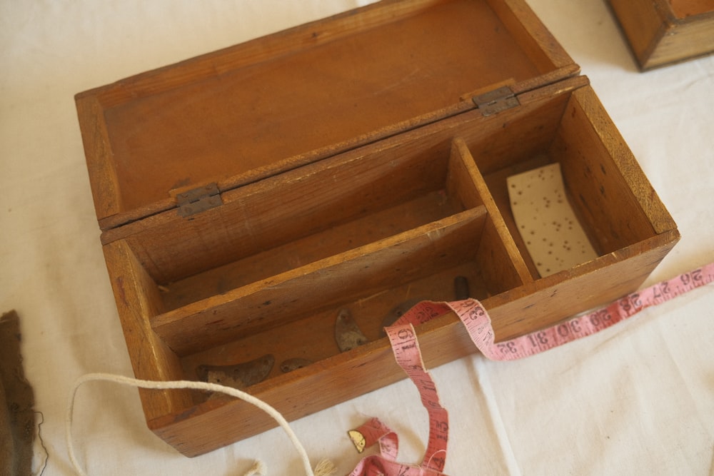 a wooden box with a measuring tape inside of it