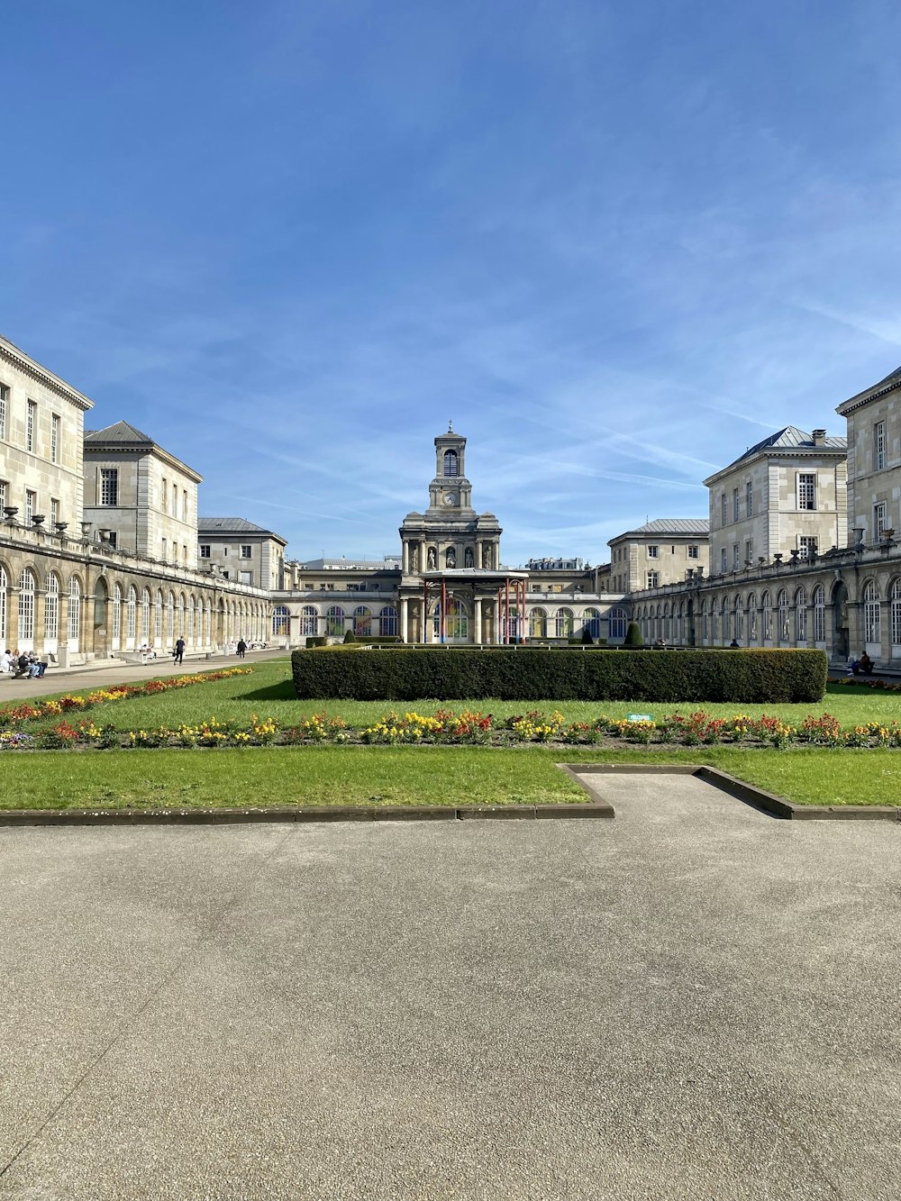 a large courtyard with a clock tower in the background