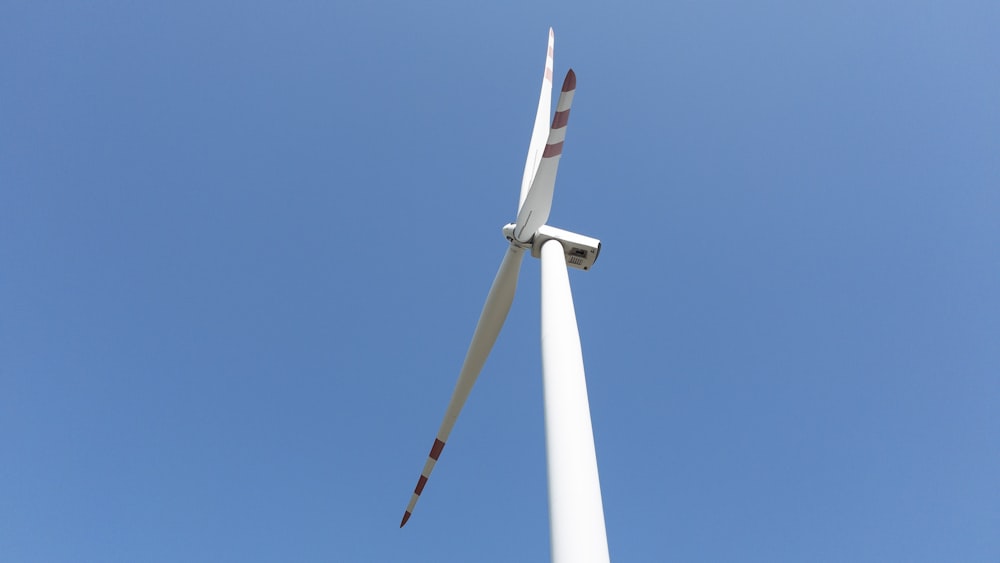 a wind turbine is shown against a blue sky