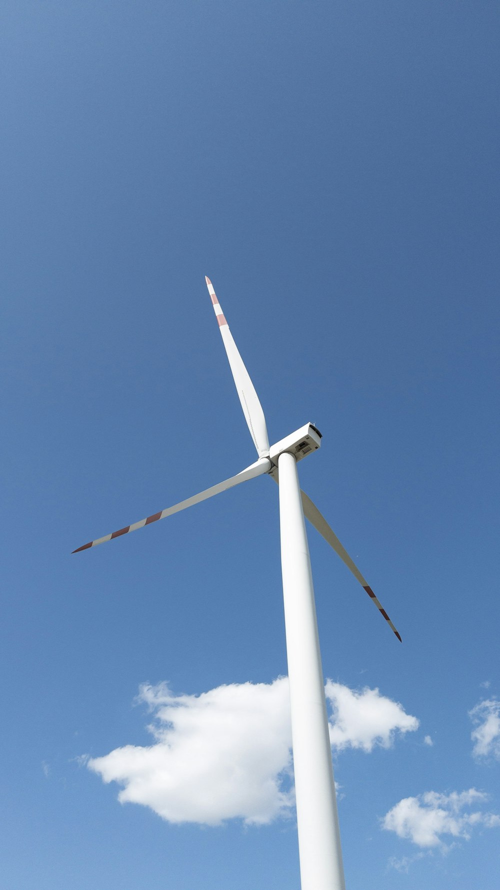 a wind turbine is shown against a blue sky