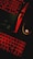 A keyboard and a computer mouse are illuminated by red backlighting. The keys and surrounding areas have a dark background, with the red glow providing stark contrast. The mouse features a prominent glowing logo, and part of a laptop or another keyboard is visible in the upper portion of the image.