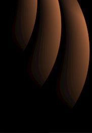 A sleek, abstract composition of layered charcoal and sand tones with subtle light and shadow play, evoking focus and clarity.