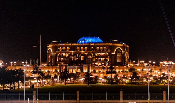 A grand entrance of Jagat Niwas Palace Hotel with golden lights glowing at dusk.