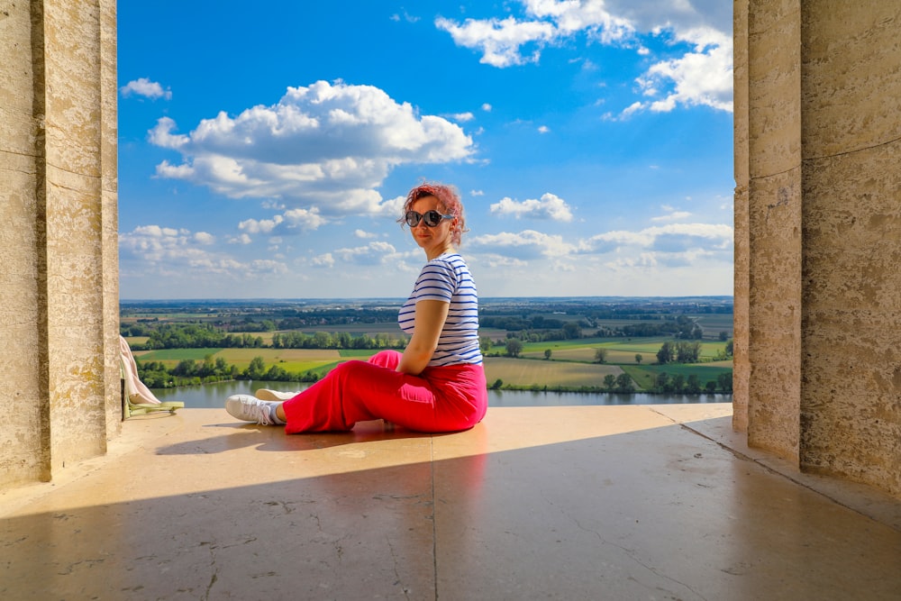 a woman sitting on the floor of a building