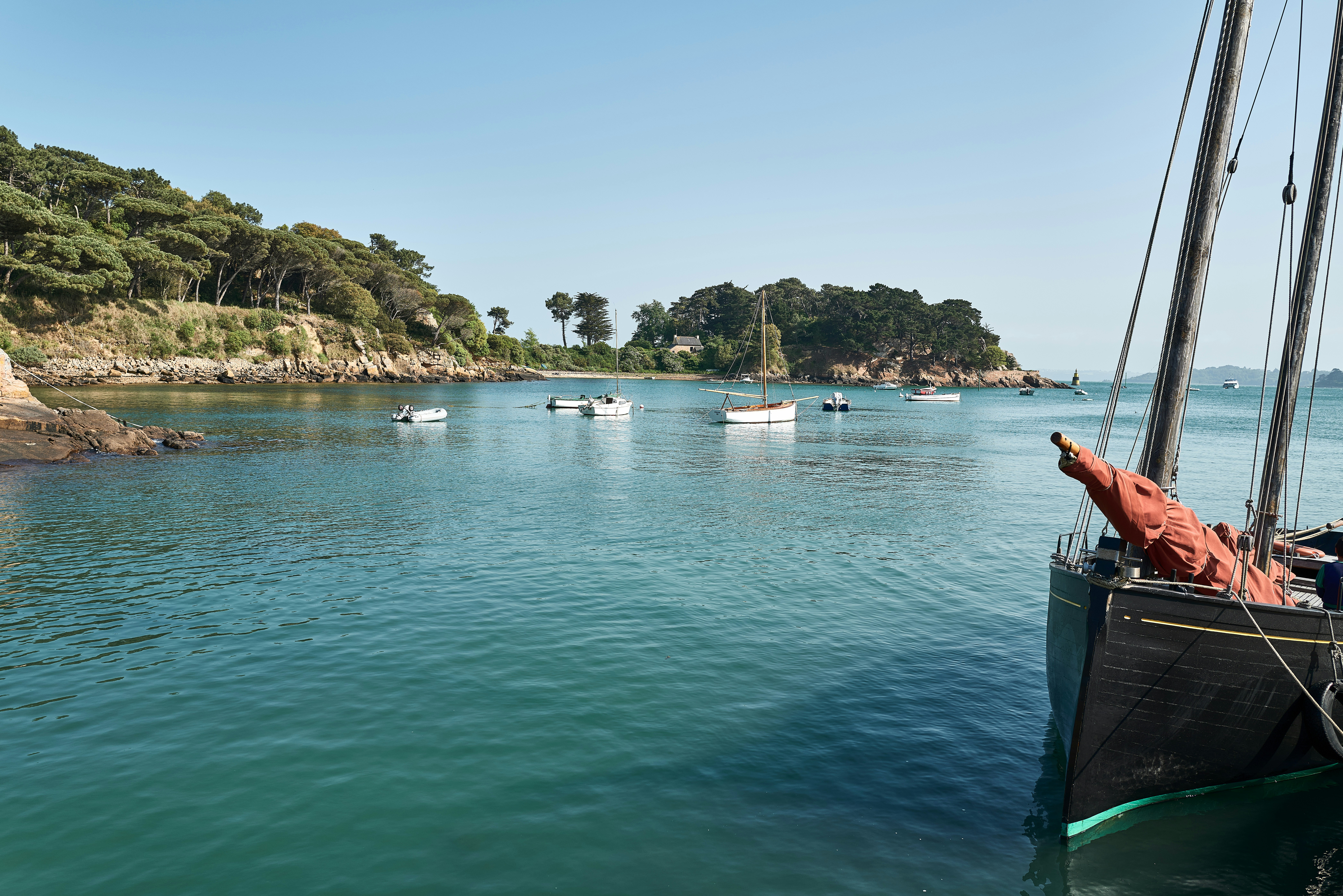 a group of boats floating on top of a body of water