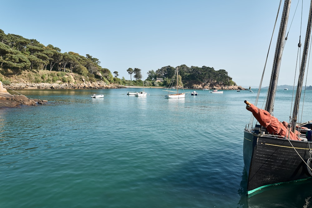 a group of boats floating on top of a body of water