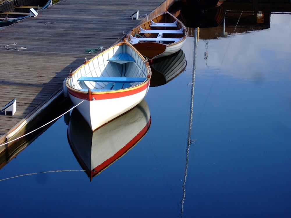 a row of boats sitting on top of a body of water