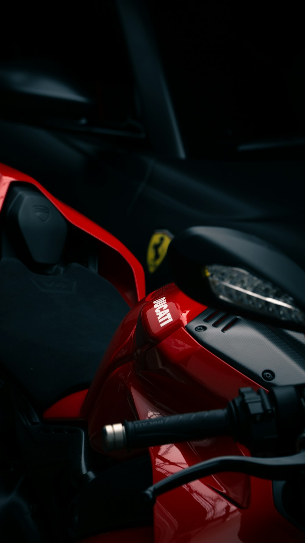 a close up of a red motorcycle with a black background
