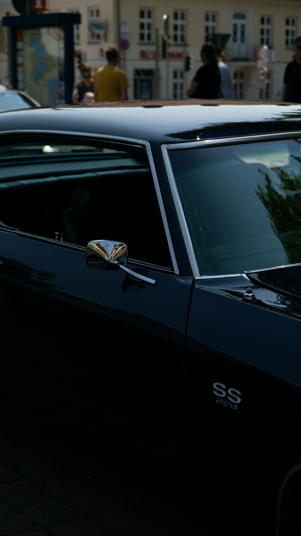 a black car parked on the side of the road