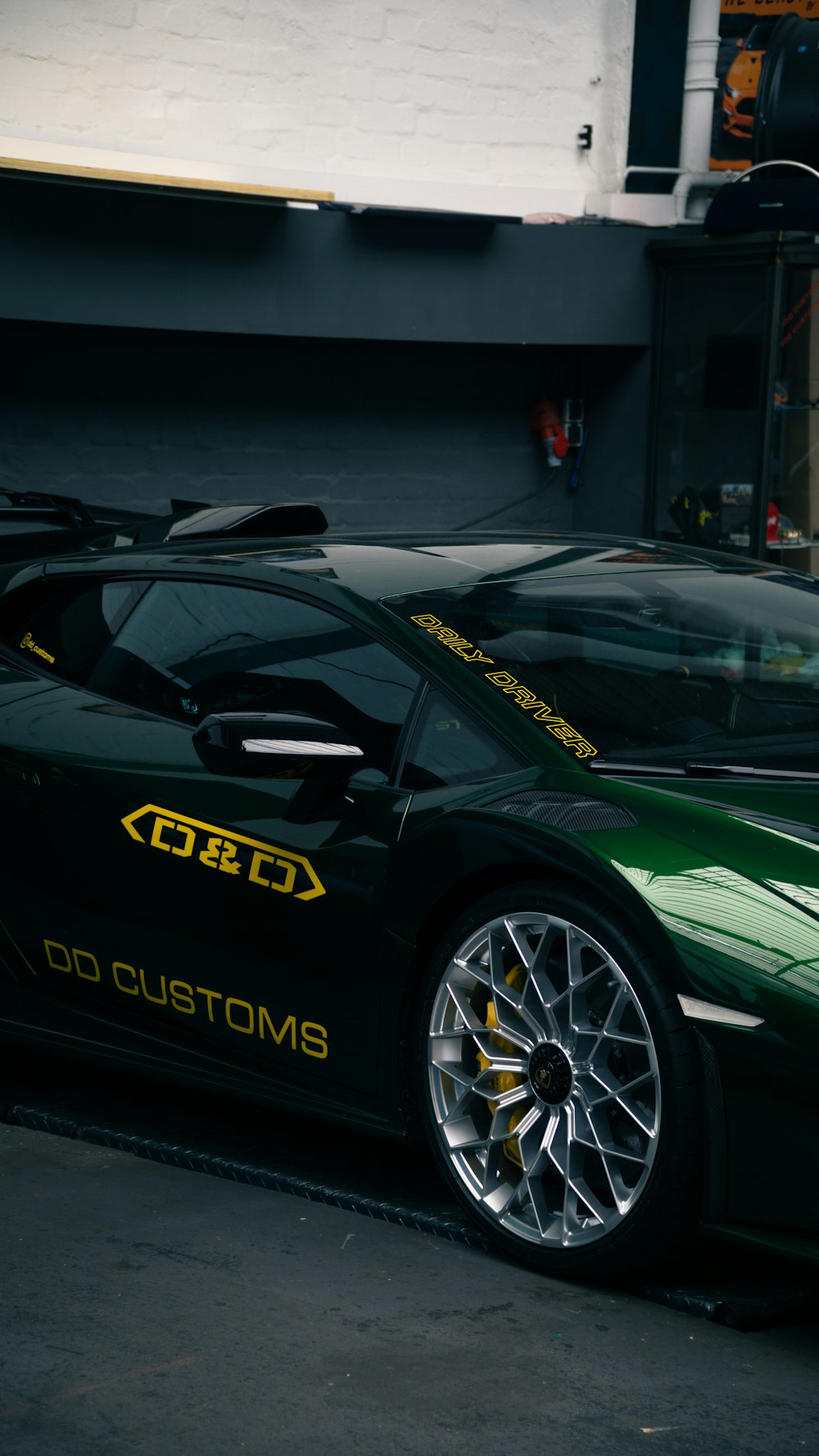 a green sports car parked in front of a building