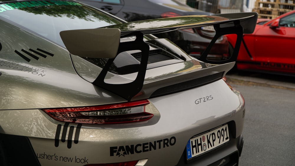 a silver sports car parked on the side of the road