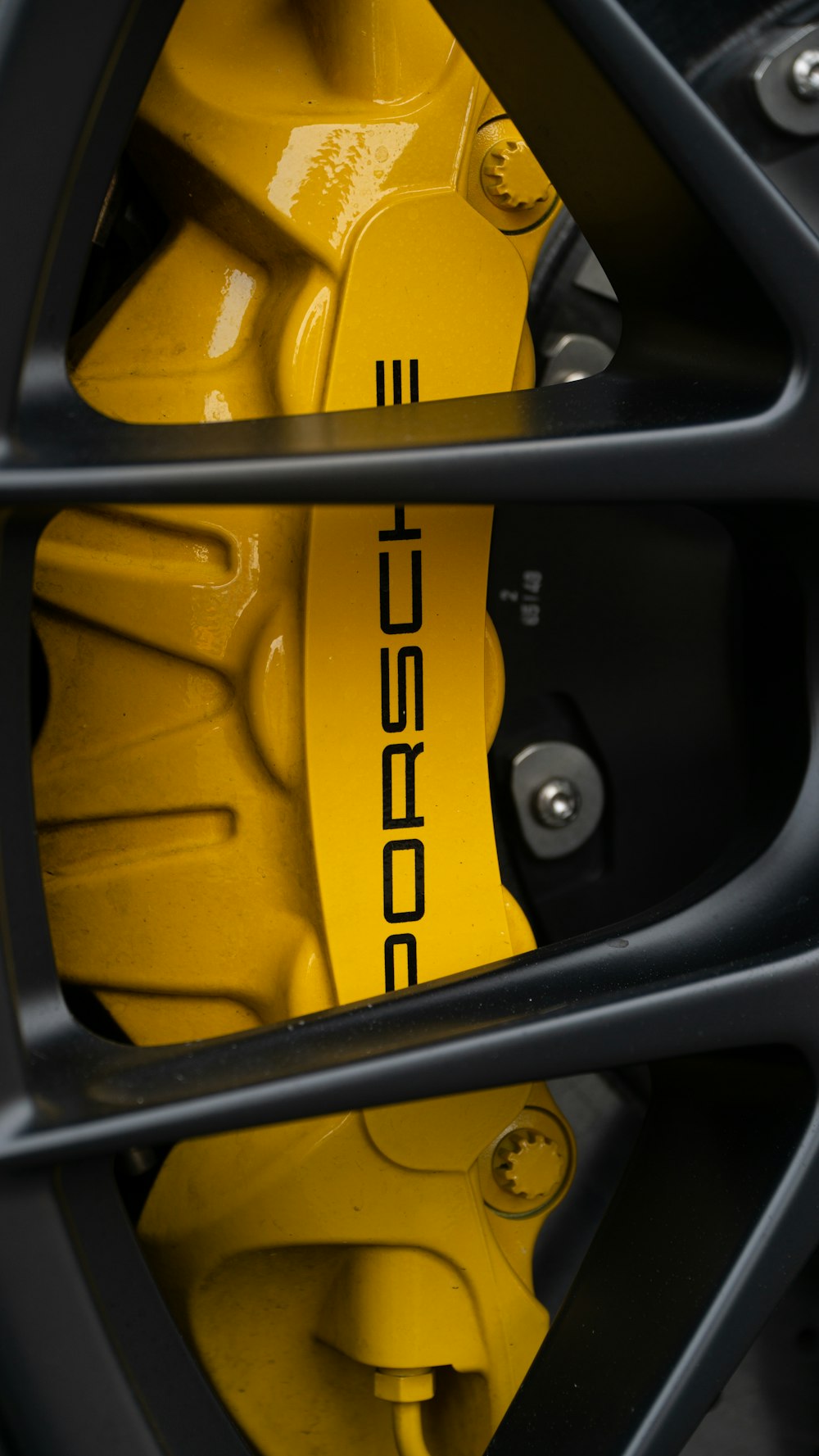 a close up of a yellow brake on a car
