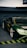 A sleek, high-performance sports car with a glossy dark green finish and a prominent rear spoiler is parked in an indoor garage. The car features custom decals, including yellow text on the windows and sides. The environment is slightly dim, highlighting the car's shiny surface and reflective qualities.