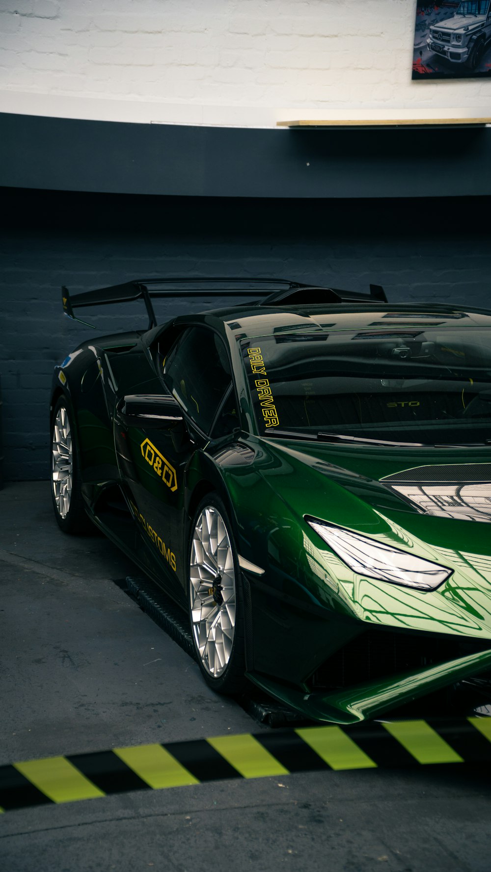 a green sports car parked in a garage